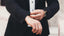 A gentleman showing a ring wearing a suit