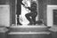 A man proposing to a woman on one knee on stairs