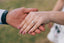 A picture of a married woman showing her wedding ring