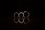 A close shot of thee rings in a black background